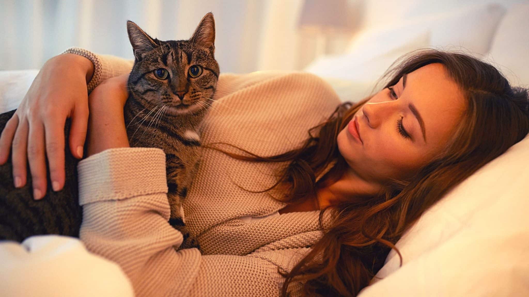 woman on the bed with cat